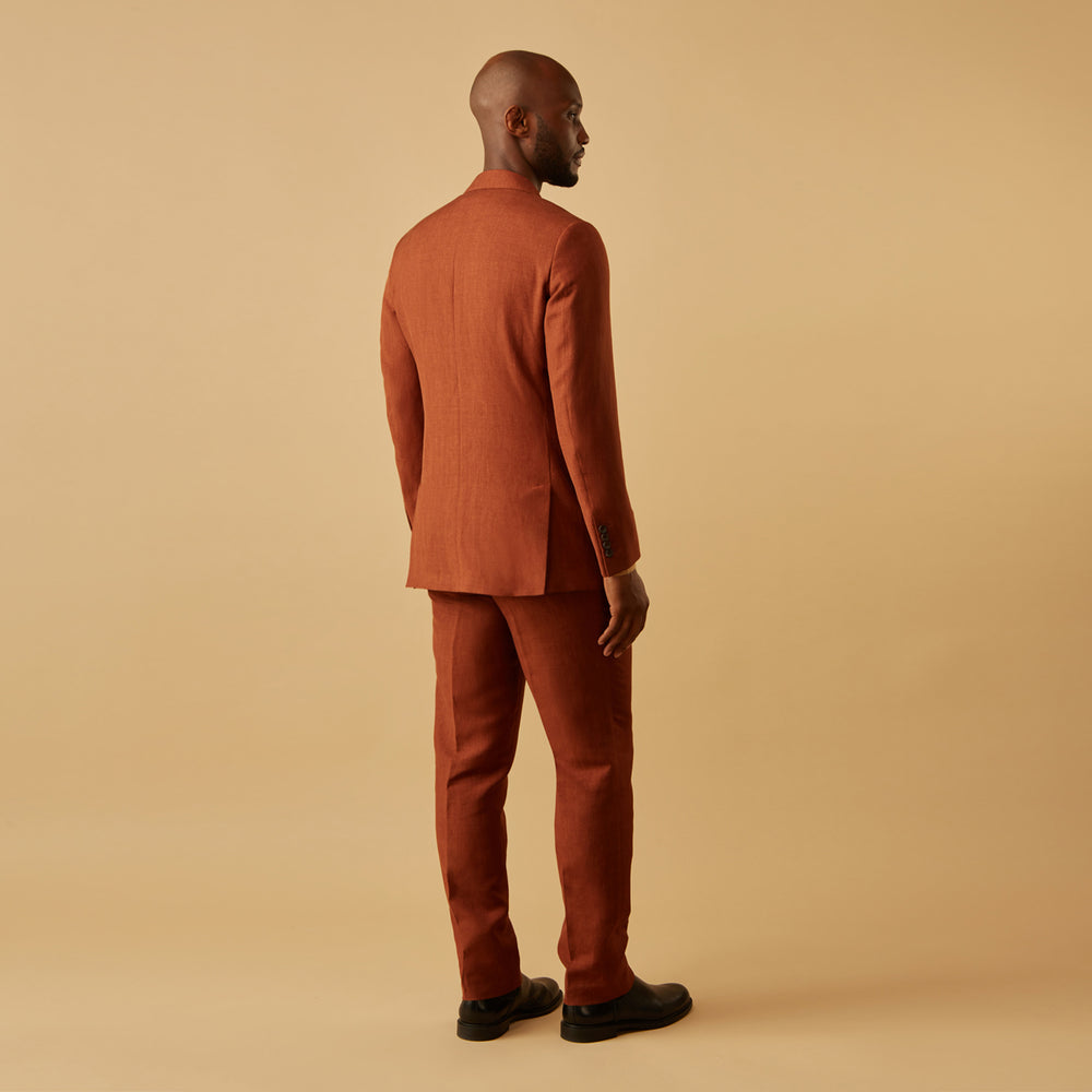 The Turnbull & Asser Rust Linen-Wool-Silk Bertie Blazer is a red double-breasted jacket with peak lapels, black buttons, and flap pockets, tailored in Italy from a luxury linen-wool-silk blend and shown on a white background.