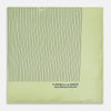 View 4 of product The Melon Green Stripe Silk Pocket Square by Turnbull & Asser features thin vertical black lines on light green silk, neatly folded to display both sides. The lower corner reads “TURNBULL & ASSER HAND PRINTED IN ENGLAND.”.