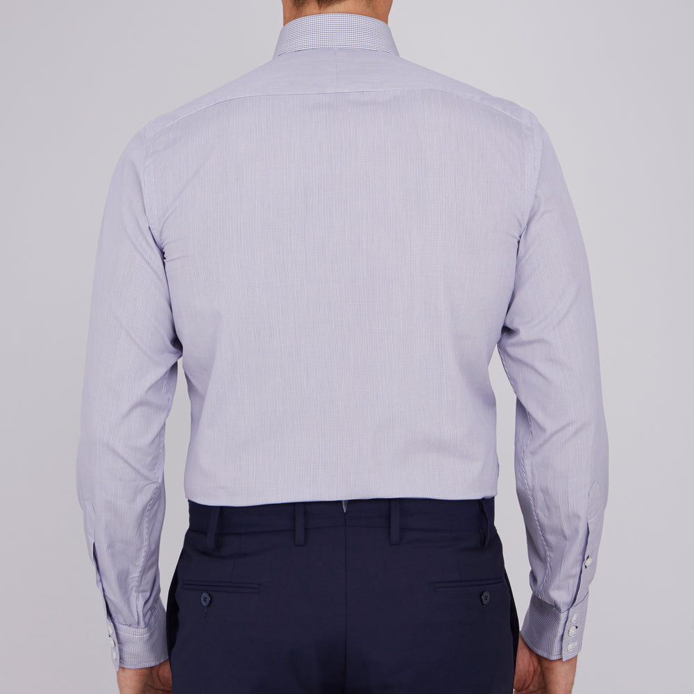 The Turnbull & Asser Slim Fit Blue Checked Shirt features long sleeves, contrasting white buttons, a regent collar, and distinct blue check pattern detailing on the cuff.