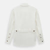 View 3 of product The Vanilla Linen Holland Shacket by Turnbull & Asser, a white Irish linen button-up with a collar, brown buttons, and four pockets, is laid flat on a white background—perfect as lightweight outerwear.