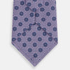View 3 of product The Turnbull & Asser Lilac Medallion Printed Silk Tie is crafted from English silk with a geometric motif of small blue circles and a subtle checkered background.