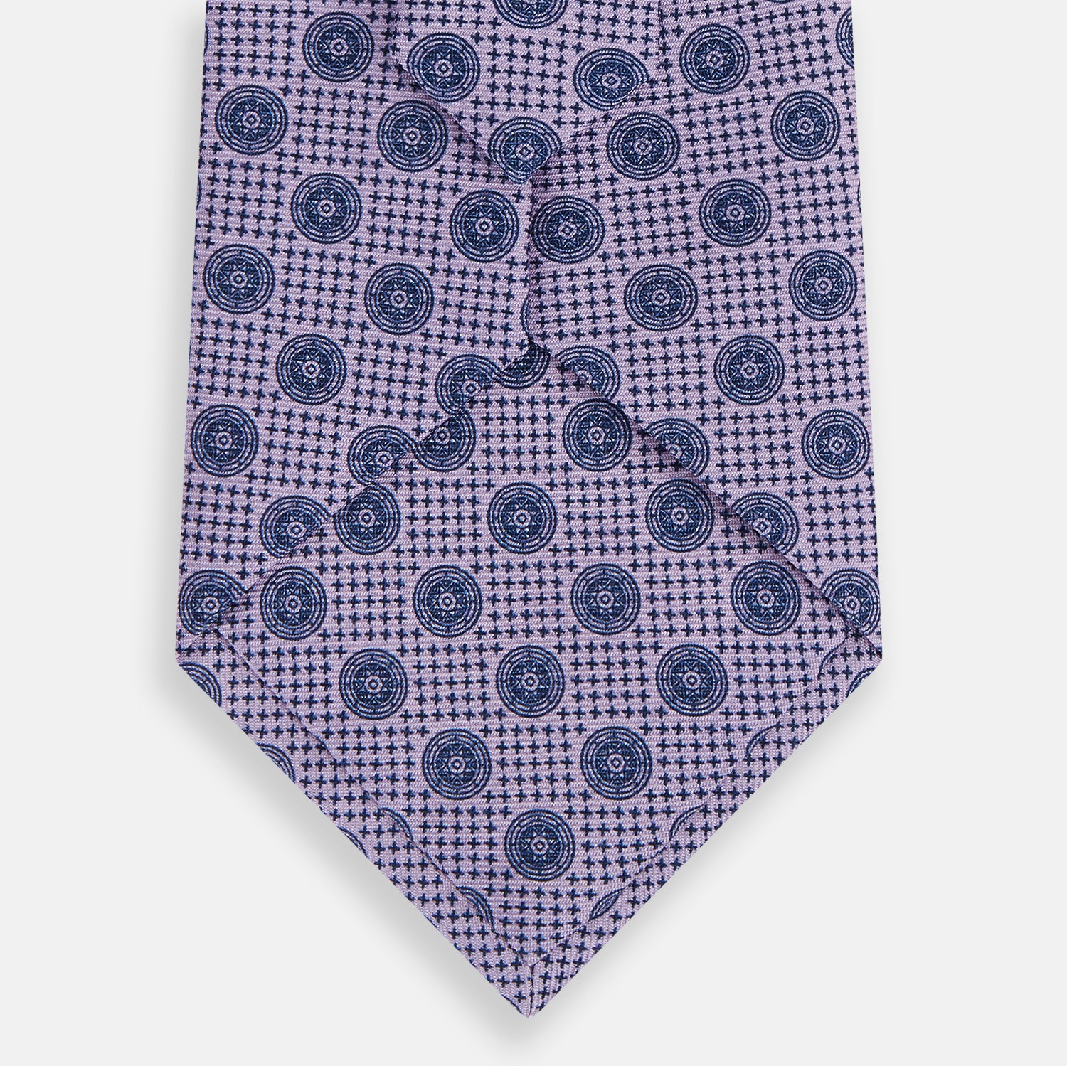 View 3 of product The Turnbull & Asser Lilac Medallion Printed Silk Tie is crafted from English silk with a geometric motif of small blue circles and a subtle checkered background.