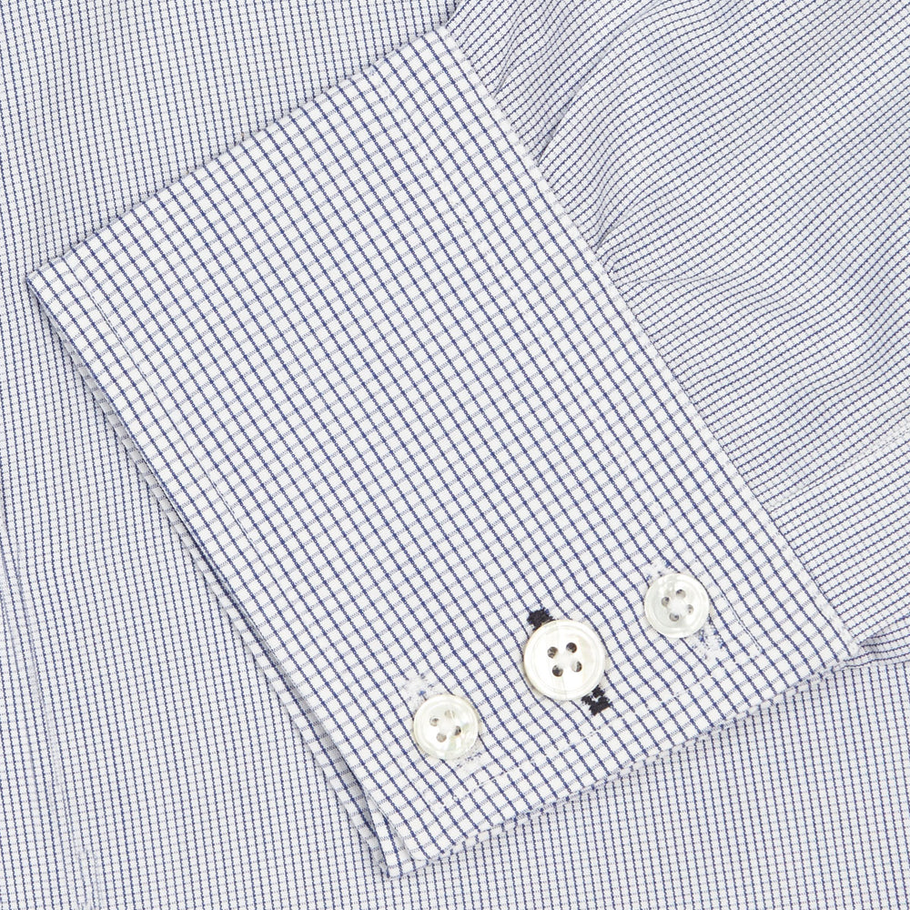 The Turnbull & Asser Slim Fit Blue Checked Shirt features long sleeves, contrasting white buttons, a regent collar, and distinct blue check pattern detailing on the cuff.