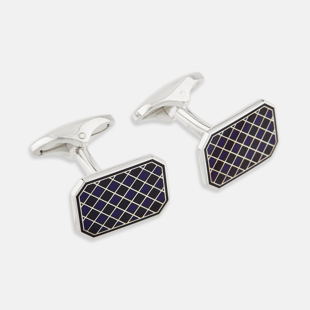 The Turnbull & Asser Navy Checkered Rectangular Enamel Cufflinks feature dark blue enamel faces with a gold grid pattern, blending masculine elegance with timeless style.