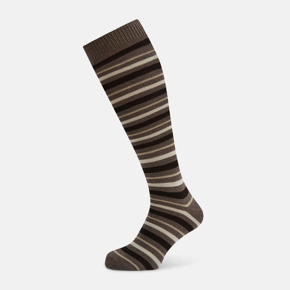 The Coffee Striped Merino Wool Long Socks by Turnbull & Asser feature knee-high length with horizontal brown, beige, and cream stripes, shown against a plain white background.