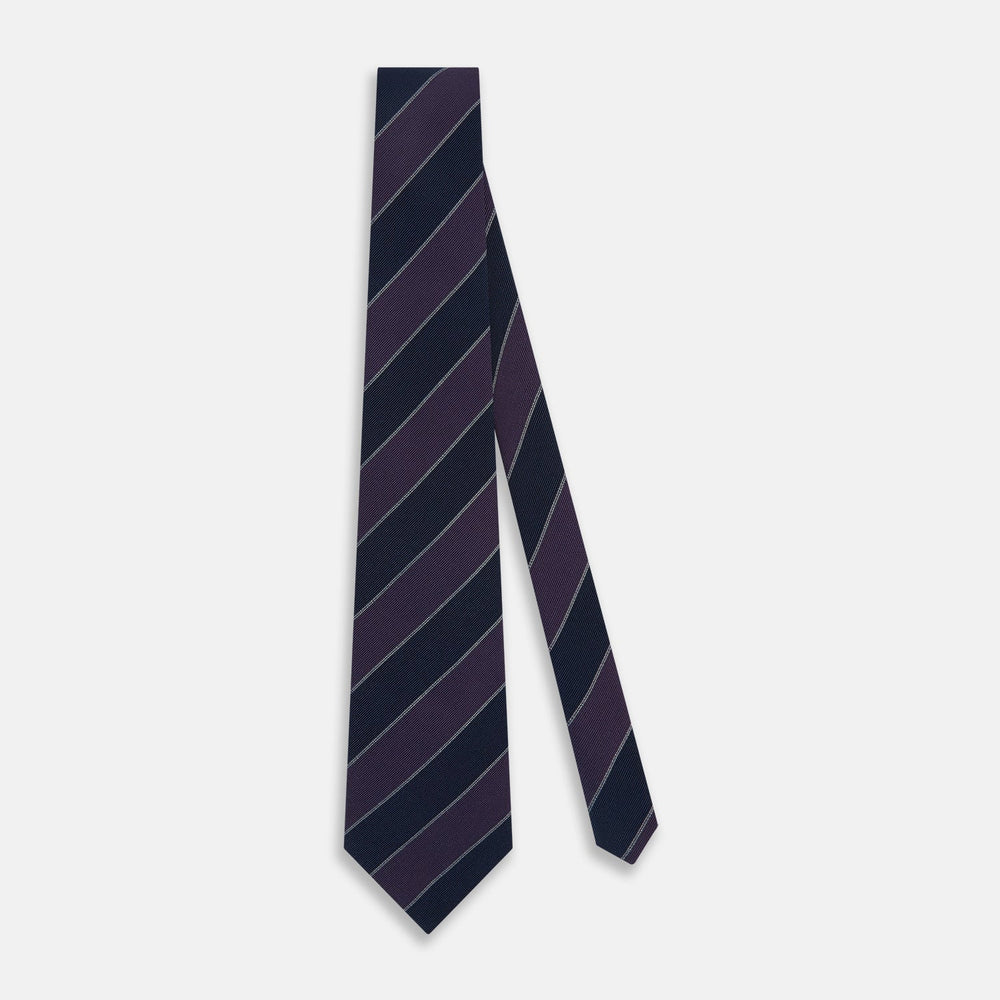 The Turnbull & Asser Purple And Navy Block Stripe Silk Blend Tie features dark navy and deep purple stripes with thin light gray lines, making it a refined formal accessory. Displayed on a white background.