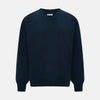View 1 of product The Turnbull & Asser Dark Green Melange Cashmere V-neck Jumper features long sleeves, ribbed cuffs and hem—an essential piece of classic knitwear displayed on a white background.