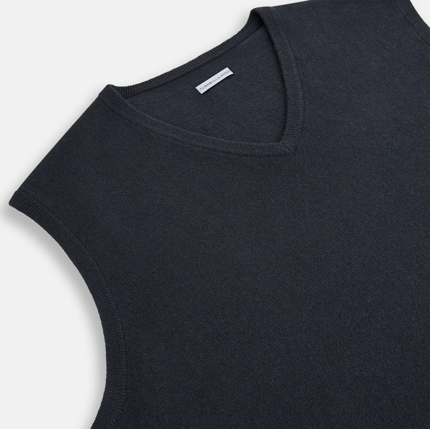 View 2 of product The Turnbull & Asser Dark Green Melange Cashmere V-Neck Vest features a sleeveless design and ribbed hem, offering a refined look, showcased on a plain white background.