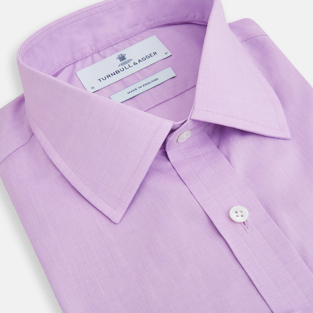 The Turnbull & Asser Purple Pink Mayfair Shirt is a men's formal, long-sleeve button-up with a classic collar and buttoned cuffs, shown in light purple against a plain white background.