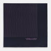 View 3 of product A navy silk pocket square with thin, even purple stripes and hand-rolled edges from Turnbull & Asser, featuring "Turnbull & Asser Hand Printed in England" printed in the corner.