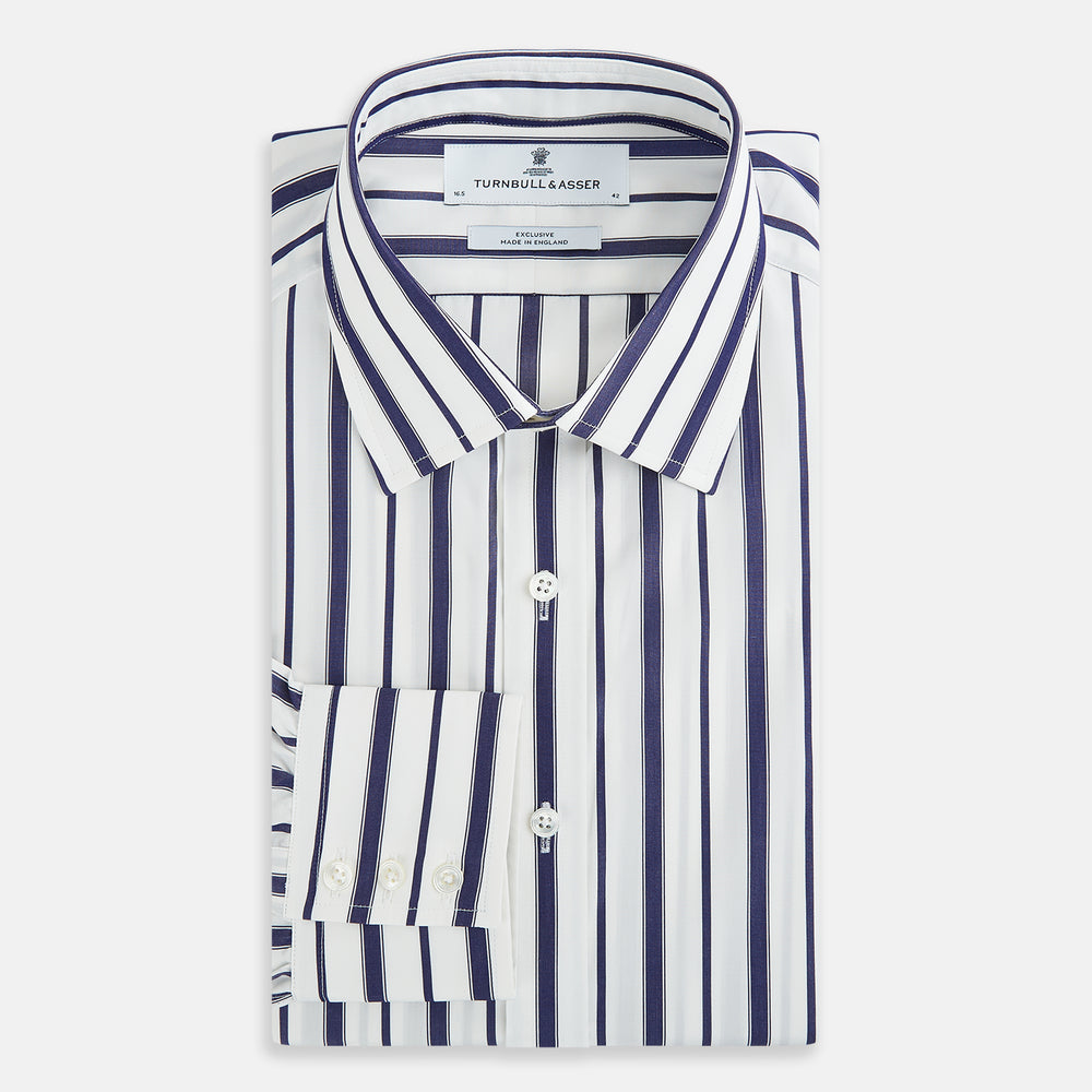 The Navy Double Stripe Mayfair Shirt by Turnbull & Asser features classic long sleeves, buttoned cuffs, a collar, and a slightly curved hem with timeless vertical navy and white stripes.