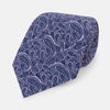 View 1 of product The Turnbull & Asser Lilac Paisley Silk Tie is shown rolled up, featuring a blue paisley pattern on a light purple background and displayed on a white surface.