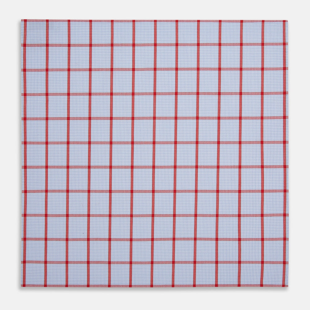 The Turnbull & Asser Hand Rolled Red Windowpane Check Handkerchief features a light blue and white gingham base with red checks—perfect as a gentleman's pocket square for a refined, classic touch.