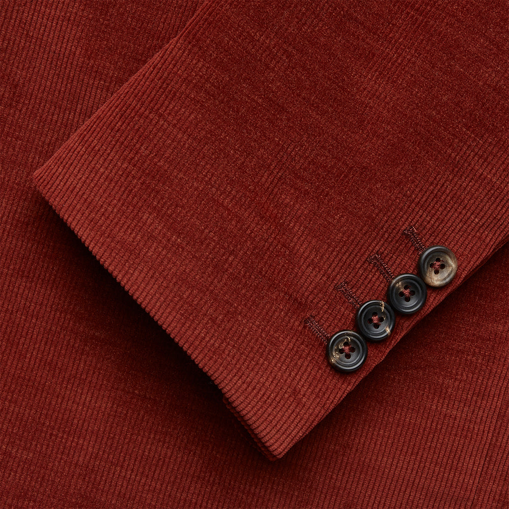 The Rust Cord Barrington Blazer by Turnbull & Asser is tailored in Italy with notch lapels, two front buttons, three pockets, and four-button cuffs, shown flat on a white background.