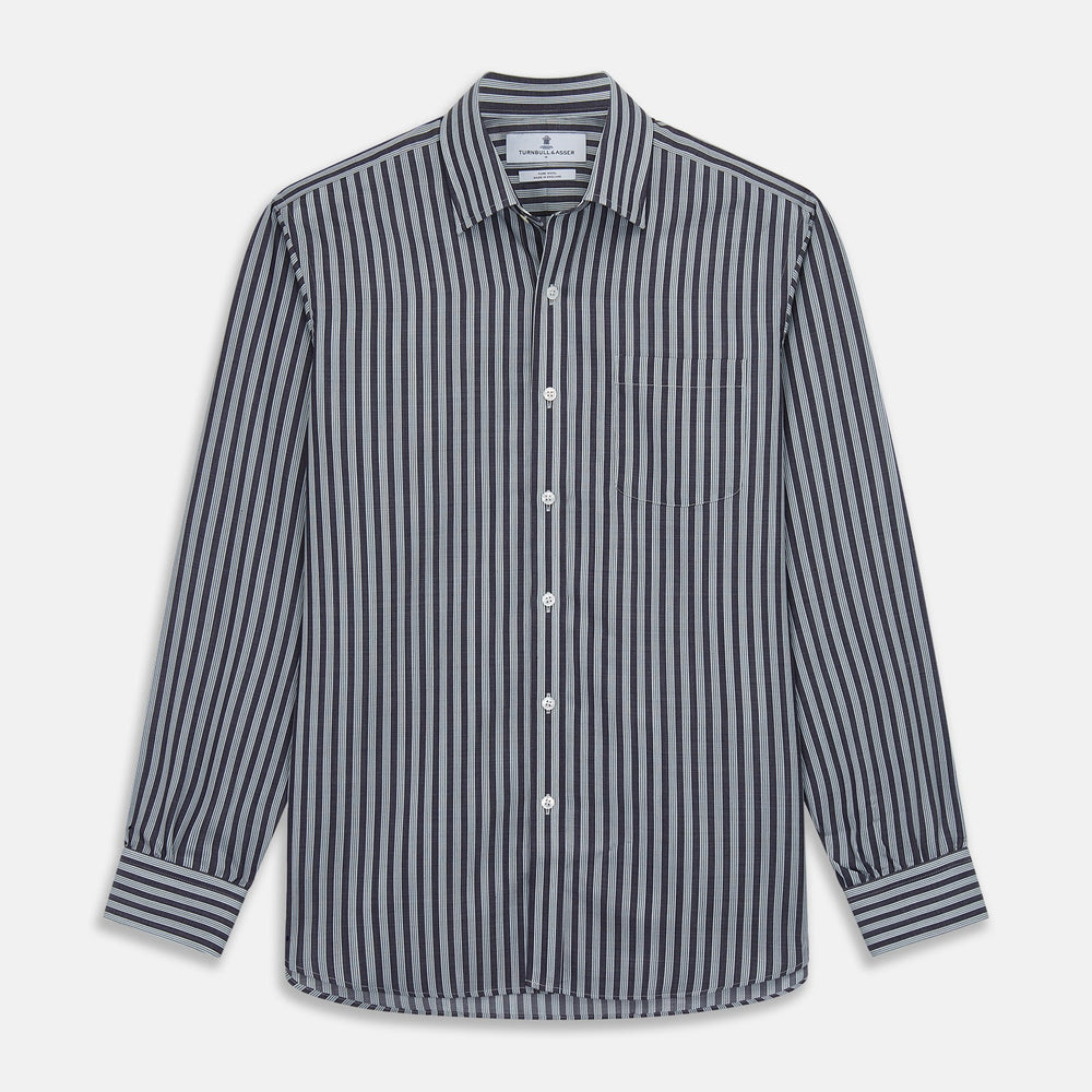Close-up of Turnbull & Asser's Navy Multi Stripe Wool Fabric, featuring diagonal white stripes, displayed inside a circular frame on a light gray background.