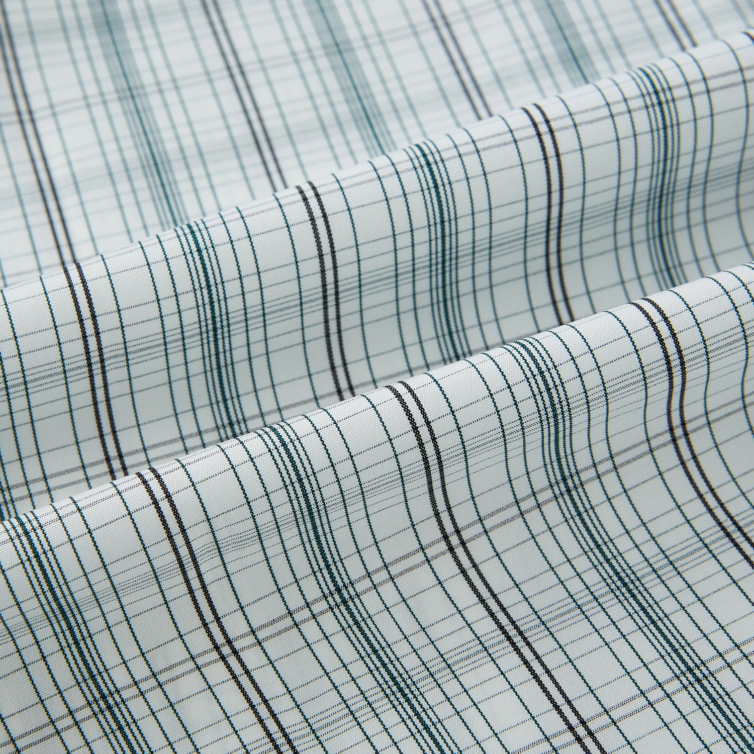 View 8 of product The Turnbull & Asser Forest Green Multi Check Westminster Shirt is a tailored, long-sleeved, button-up shirt with a collar and a white base featuring light blue and green plaid, displayed flat on a white background.