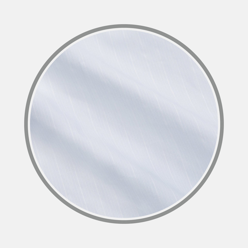 A close-up of Turnbull & Asser's Cloudy Blue Stripe Cotton Fabric shows its subtle diagonal stripes and lightly textured surface, displayed within a circular frame on a plain light background.