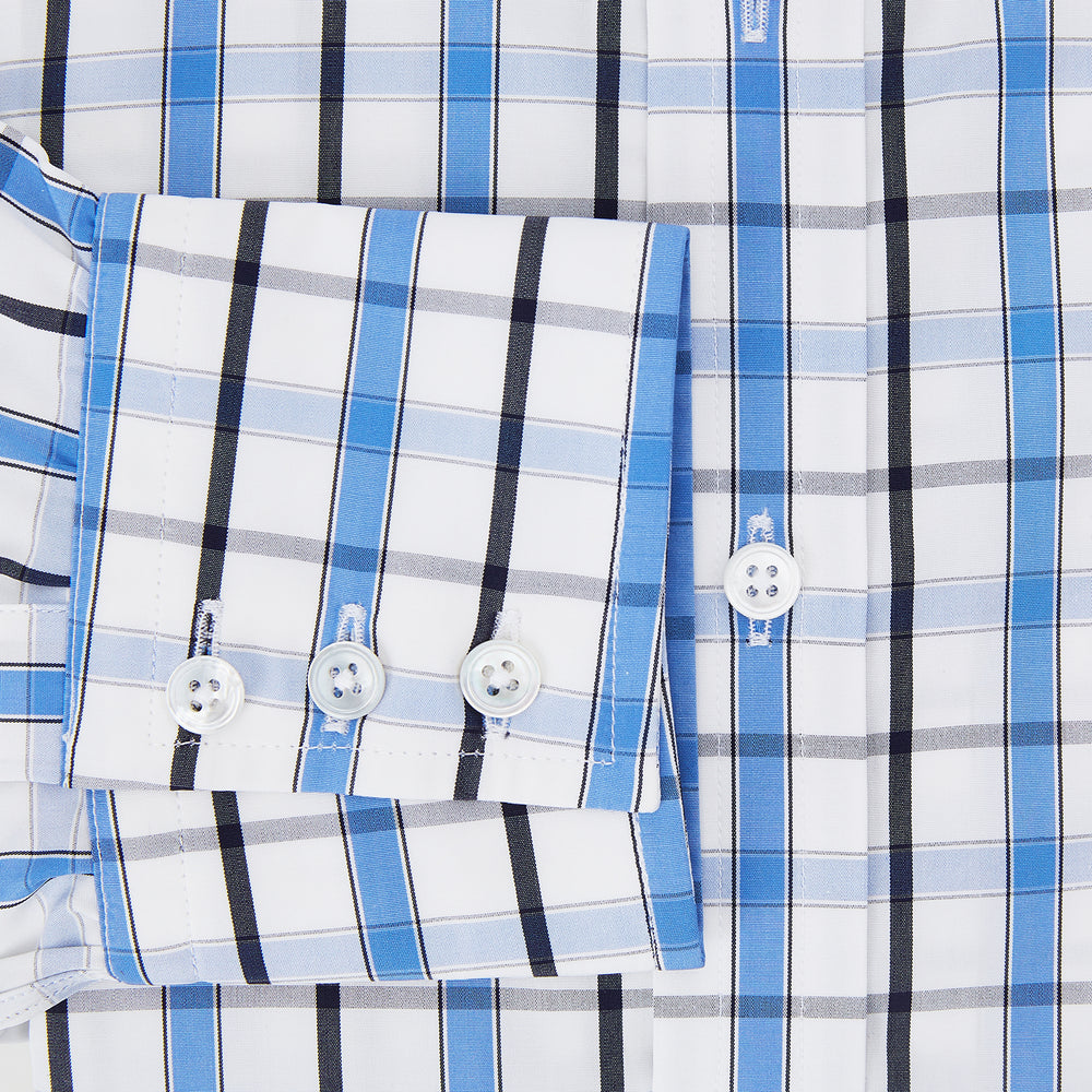 The Turnbull & Asser Blue and Navy Combination Check Mayfair Shirt features a classic button-up style with long sleeves, T&A collar, and a blue, navy, and white check pattern, shown against a plain white background.