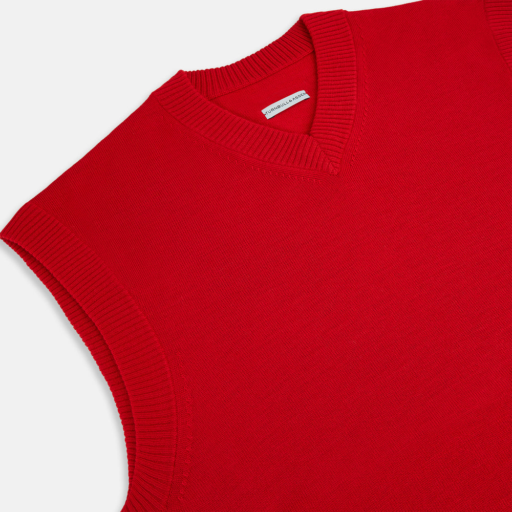 The Turnbull & Asser Red Fine Merino V-Neck Vest is a men's sleeveless jumper featuring ribbed edges, showcased against a plain white background.