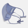 View 4 of product The Turnbull & Asser White & Navy Multi Check Commuter Mask comes with 3 Viroformula™ filters and two adjustable tie straps on each side, shown on a plain white background.