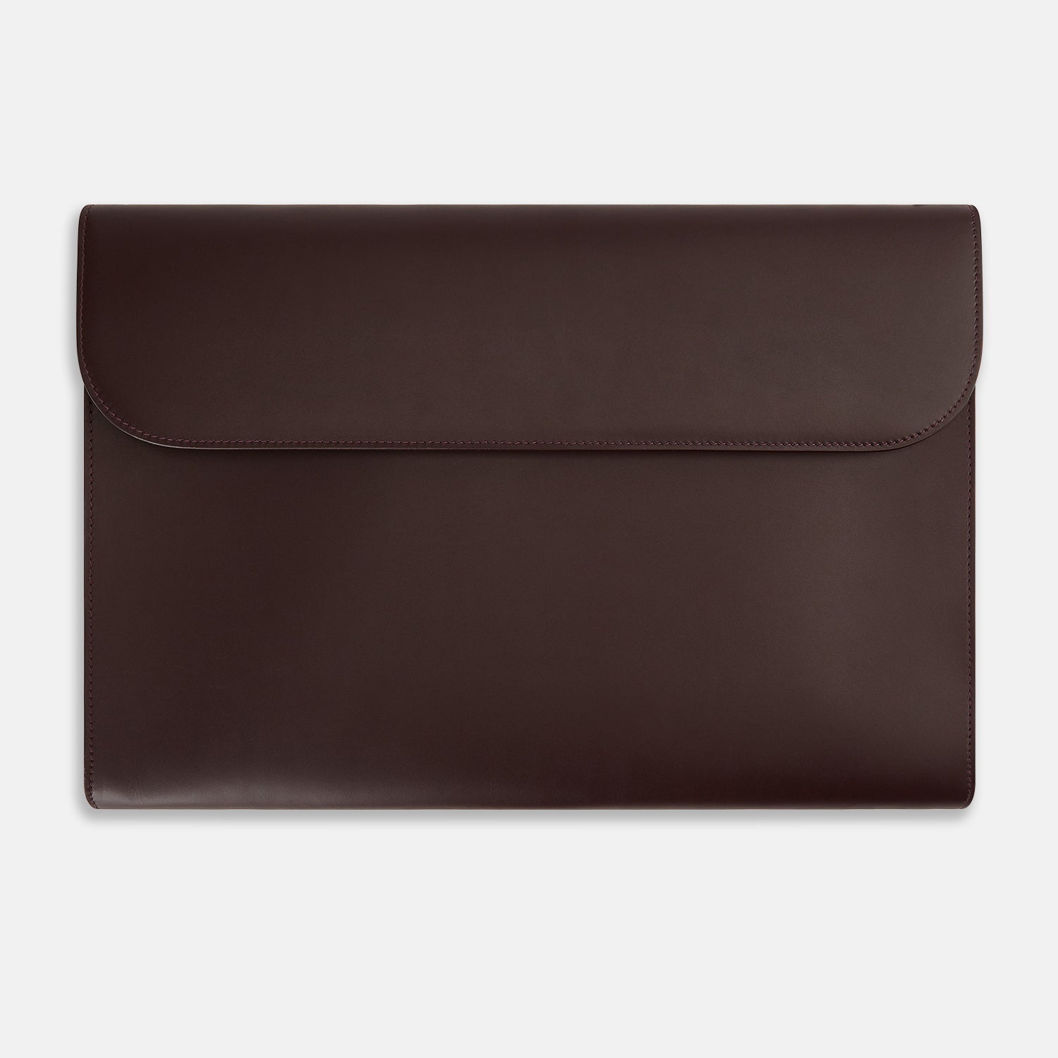 Image 1 of product The Turnbull & Asser Burgundy Leather Snap-Fasten Pouch is a sleek, envelope-style laptop accessory with a smooth finish, curved flap, and elegant snap closure, ideal for business travel against a white background.
