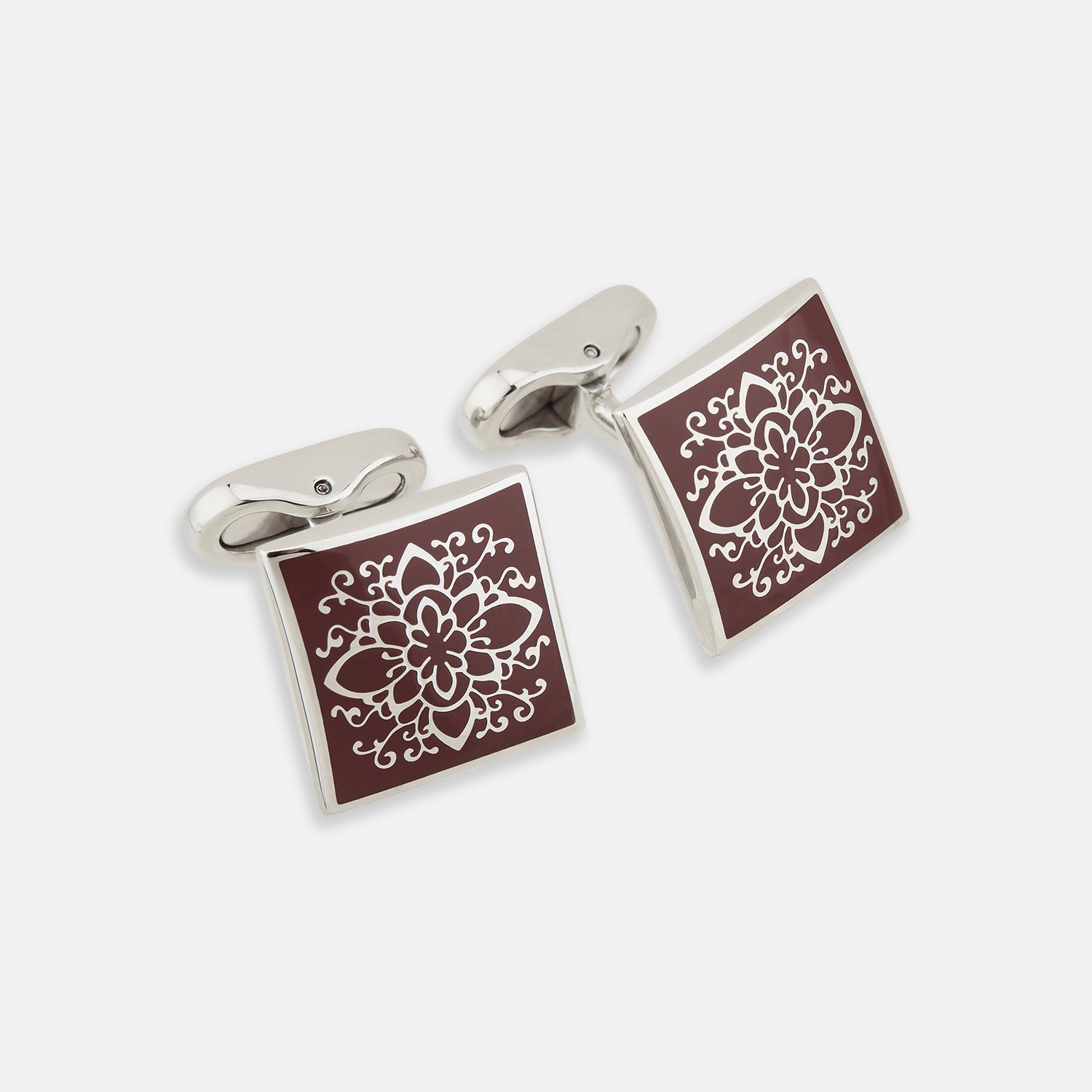 View 1 of product Turnbull & Asser Burgundy Floral Square Cufflinks feature a reddish-brown enamel face with an intricate white mandala pattern at the center, all set in elegant sterling silver.