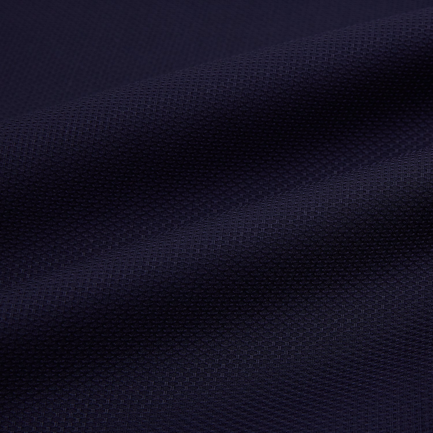 View 8 of product The Navy Textured Windsor Shirt by Turnbull & Asser features long sleeves, a Windsor collar, buttoned cuffs, and white buttons—a fine example of British craftsmanship—set against a plain white background.