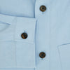 View 4 of product The Blue Hyde Overshirt by Turnbull & Asser features a light blue hue, long sleeves, a button-up front, and a single chest pocket. Crafted from sanforised cotton and shown laid flat on a white background.