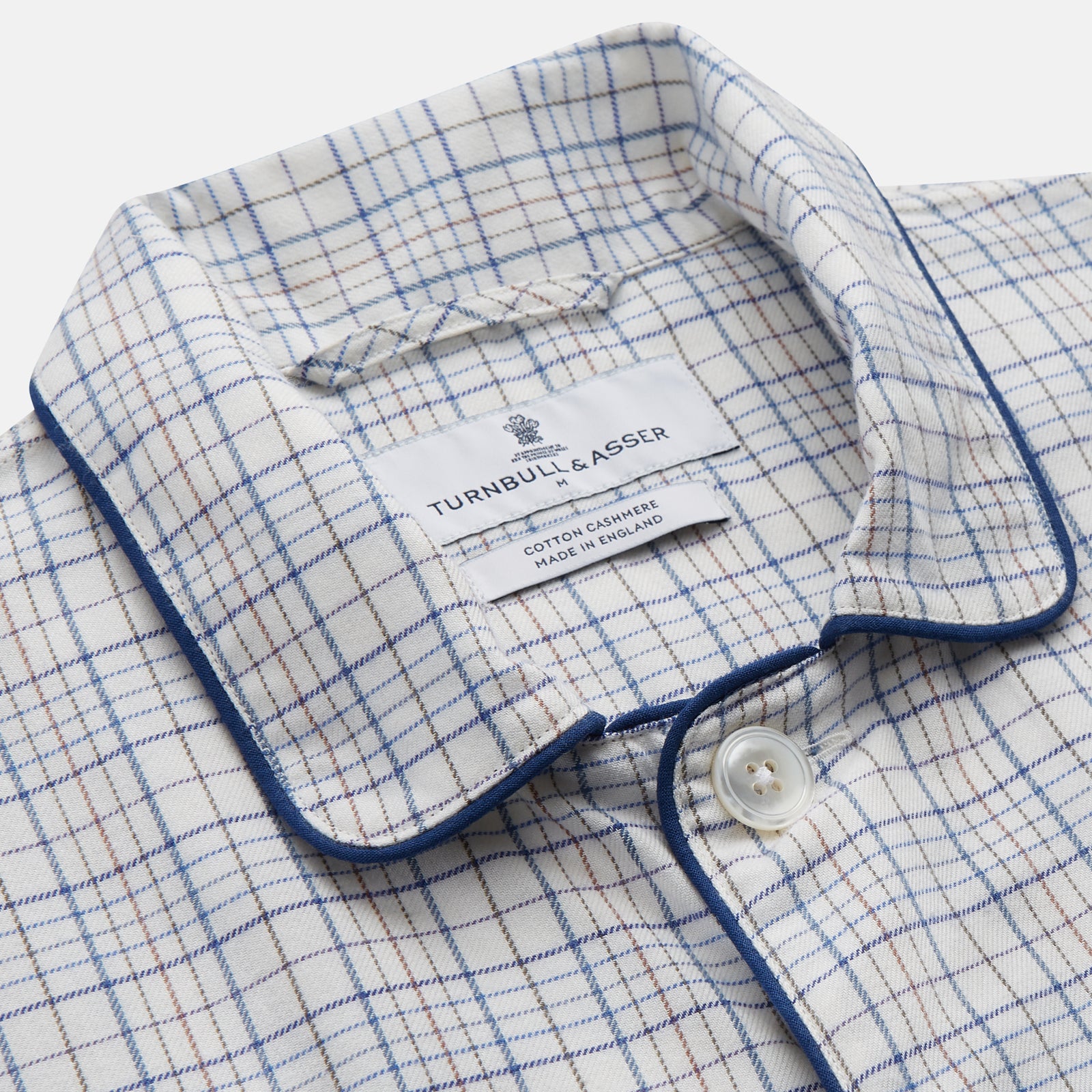 View 4 of product The Turnbull & Asser Blue Multi Check Cotton-Cashmere Modern Pyjama Set features a two-piece design with a long-sleeve button-up top with breast pocket and matching elastic-waist pants in a blue and white check pattern.