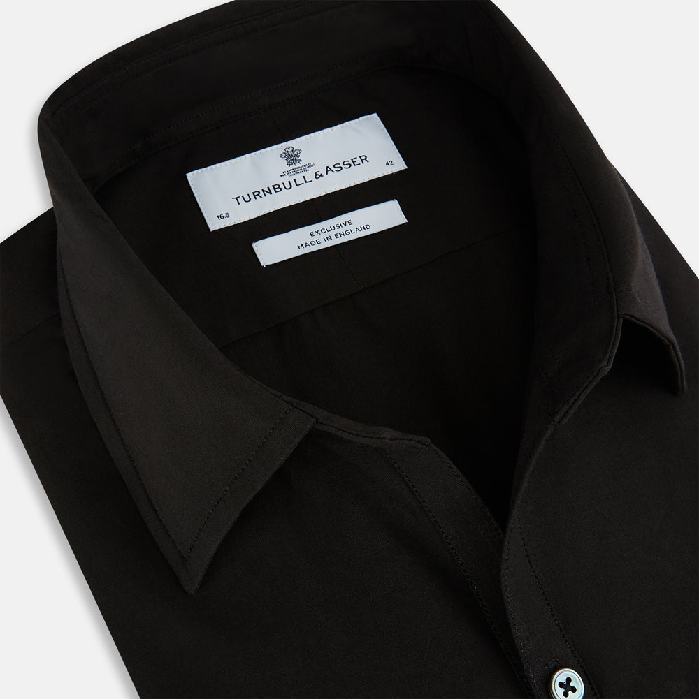 A long-sleeved, collared MIDNIGHT BLUE WINDSOR SHIRT by Turnbull & Asser, laid flat on a white background, highlights classic British craftsmanship.