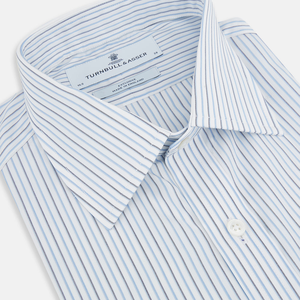 The Turnbull & Asser Navy and Blue Shadow Stripe Mayfair Shirt, featuring a classic T&A collar and buttoned cuffs, is laid flat on a white background.