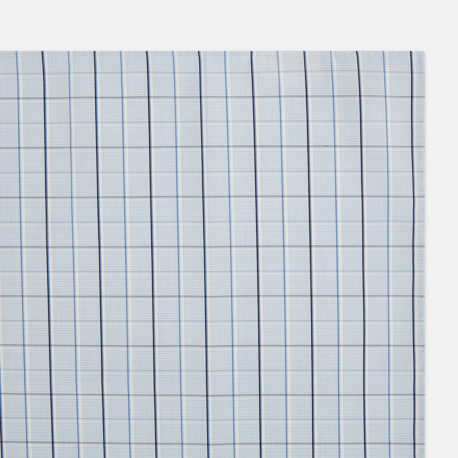 View 2 of product The Turnbull & Asser Navy and Blue Combination Check Hand-Rolled Handkerchief features a classic check pattern in navy and blue with thin white lines, shown laid flat on a white background.