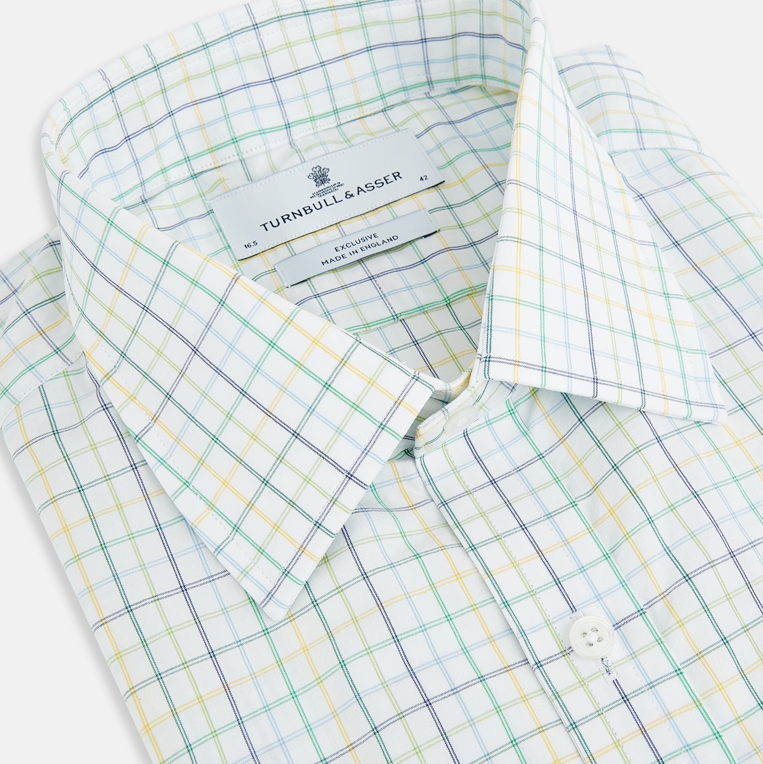 View 2 of product The Turnbull & Asser Multi Tone Double Grid Check Mayfair Shirt is a long-sleeve, button-up with a classic collar, showcasing pure cotton light blue, green, and yellow grid checks on white, neatly displayed flat against a white surface.