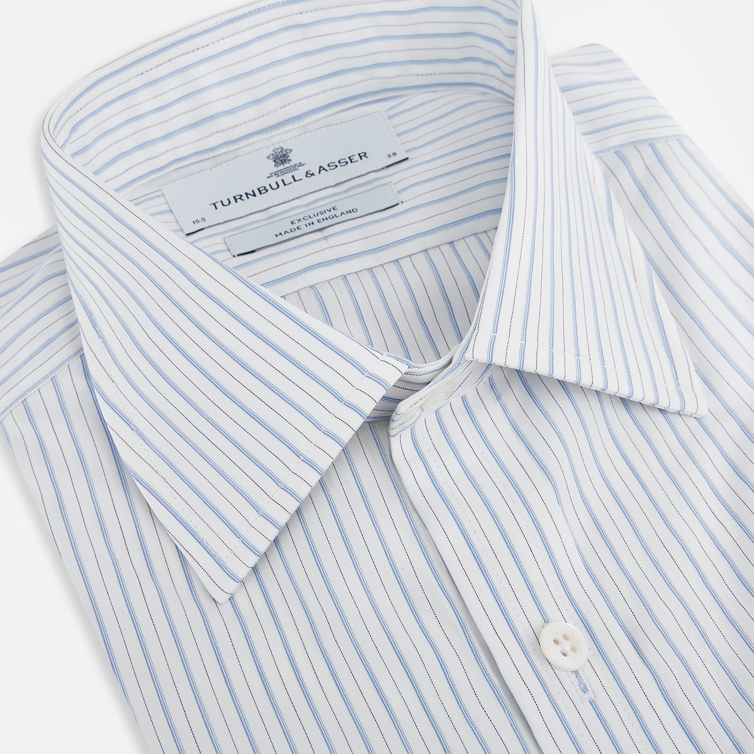 View 2 of product The Turnbull & Asser Sky Blue Combination Stripe Mayfair Shirt features long sleeves, a T&A collar, buttoned cuffs, and thin vertical stripes in blue, shown on a plain white background.