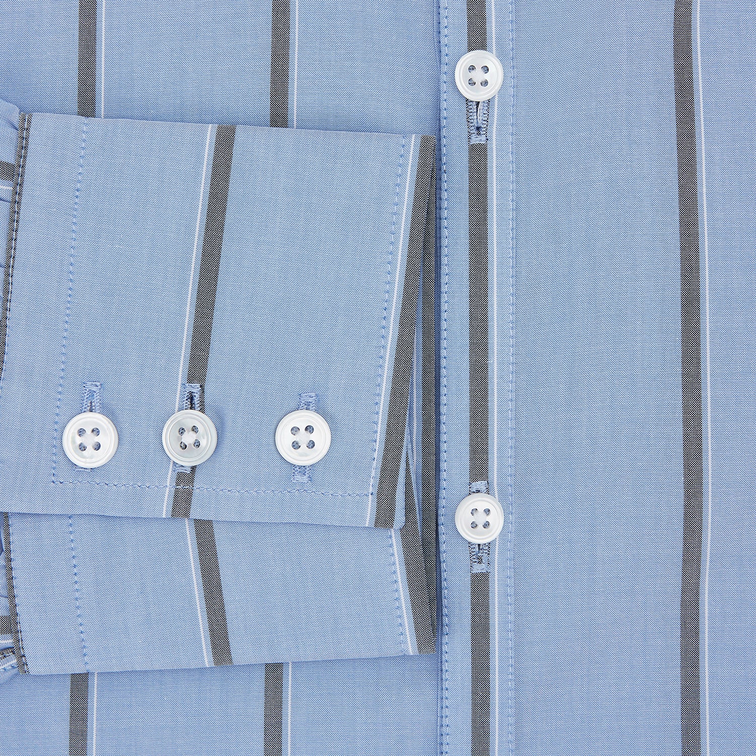 View 4 of product The Sky Blue Track Stripe Westminster Shirt by Turnbull & Asser features long sleeves, a Turnbull collar, and vertical dark blue and white stripes, displayed flat on a white surface.
