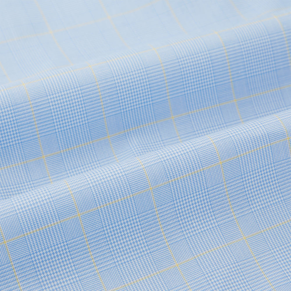 The Turnbull & Asser Blue Prince of Wales Check Pyjama Shirt features long sleeves, a notched collar, a left chest pocket, and a subtle check pattern, shown laid flat on a white background.