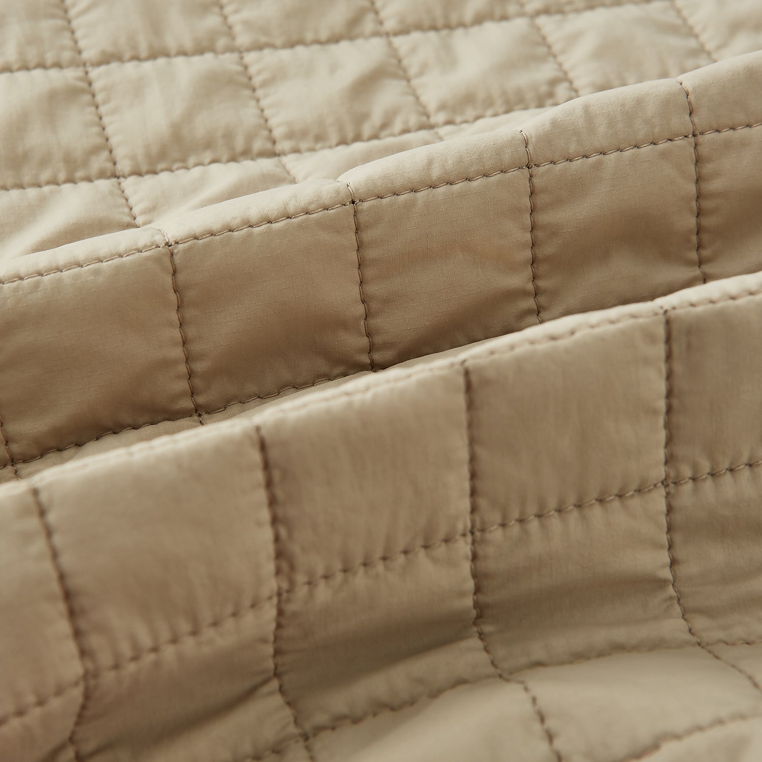 Image 4 of product The Turnbull & Asser Sand Double-Breasted Quilted Gilet features a sleeveless design, brown buttons, slanted chest pocket, and two zippered side pockets—perfect for modern layered dressing. Shown on a plain white background.