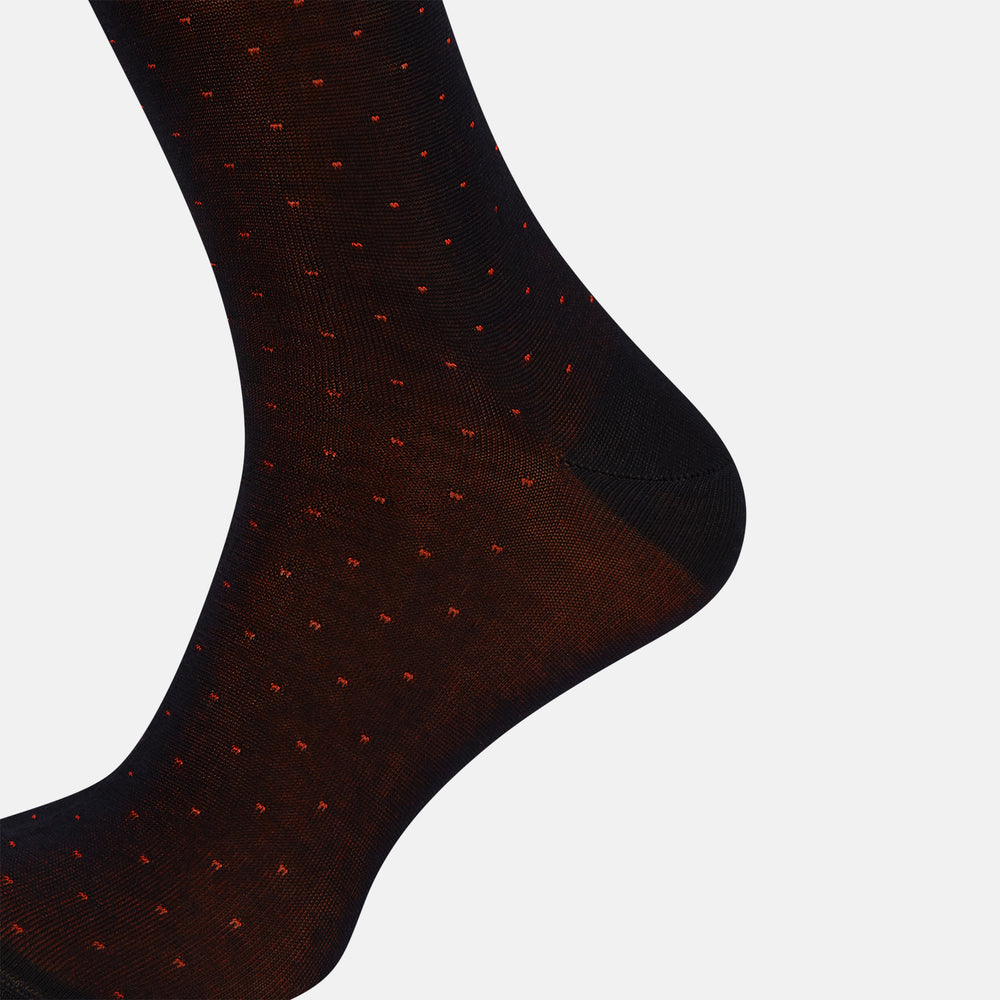 The Turnbull & Asser Navy/Red Polka Dot Mid-Length Sock is shown against a white background, featuring small red dots and solid black cuff, heel, and toe for classic style.