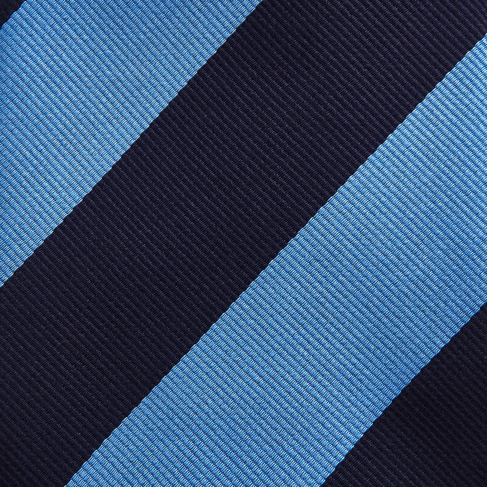 The BLOCK STRIPE NAVY RIVER TIE by Turnbull & Asser features bold navy and light blue diagonal stripes, rolled up neatly on a white background—a stylish essential for elevating any formal look.