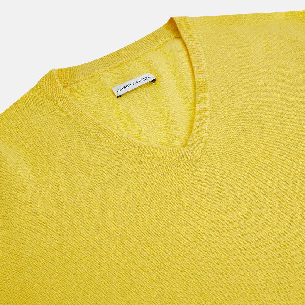 The Turnbull & Asser Canary Yellow Cashmere V-neck Jumper features long sleeves and ribbed cuffs and hem, shown against a white background.
