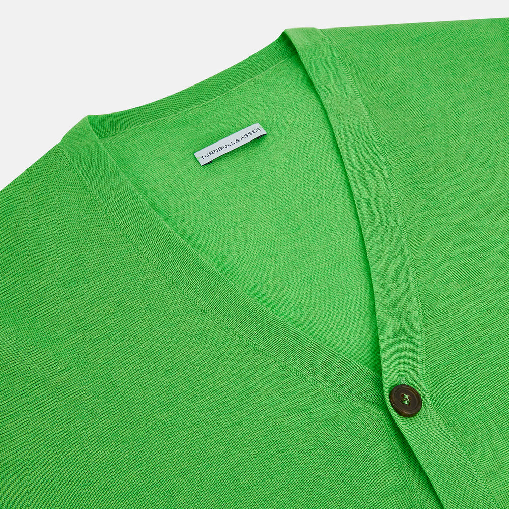 The Turnbull & Asser Lime Green Fine Merino V-Neck Cardigan features long sleeves and dark brown front buttons, shown against a plain white background.