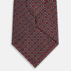 View 3 of product The Turnbull & Asser Burgundy Diamond Silk Tie features a red silk background with a repeating geometric diamond pattern of blue and white squares, exemplifying British craftsmanship.