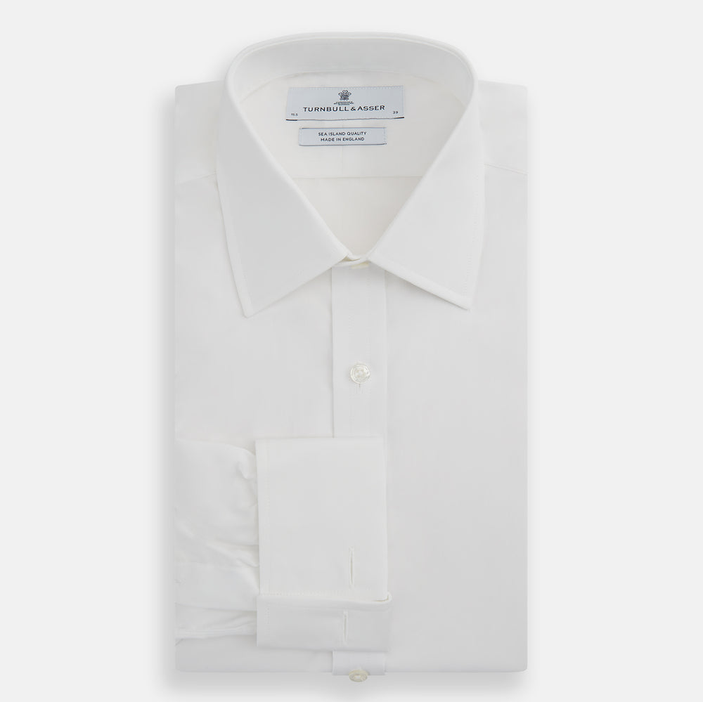 The Turnbull & Asser White Sea Island Quality Cotton Shirt features a T&A collar, double cuffs, and long sleeves, displayed against a white background.