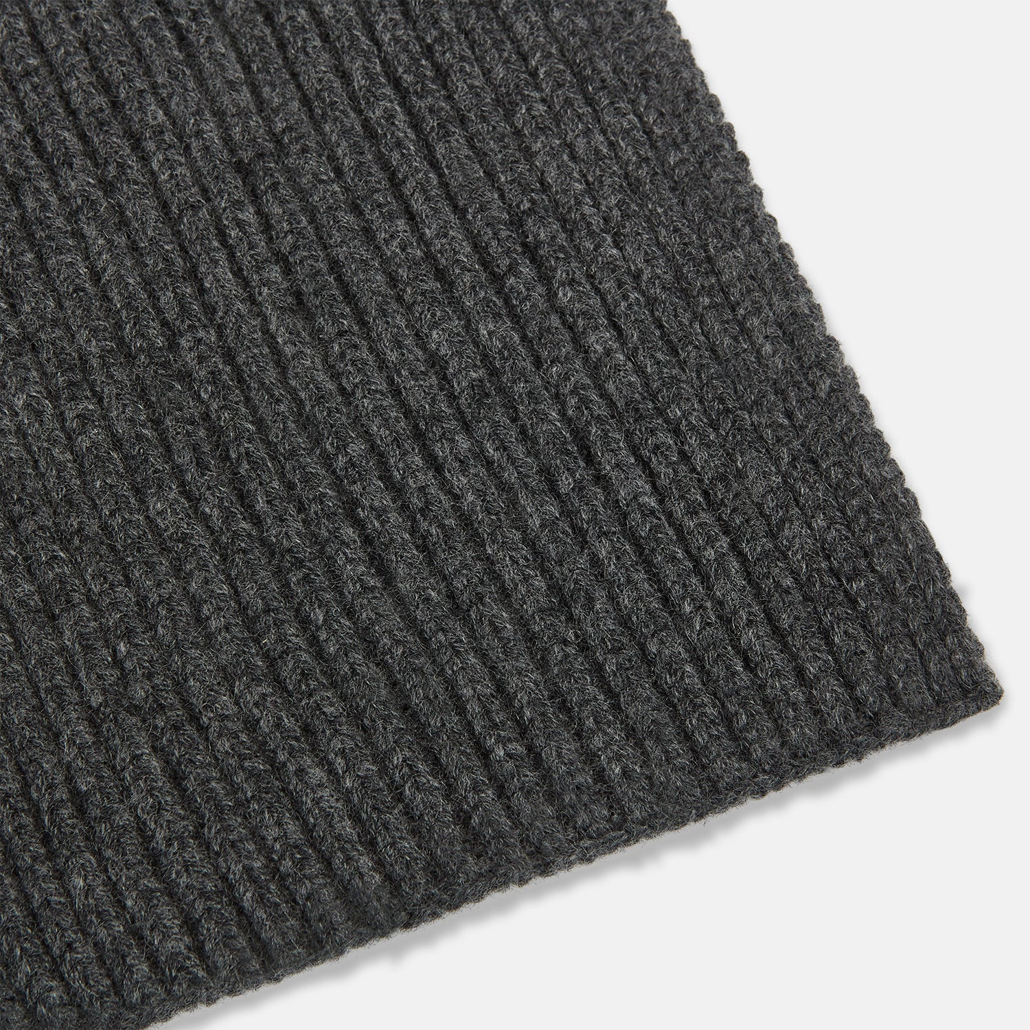 Image 2 of product The Turnbull & Asser Graphite Rib-Knit Cashmere Scarf, a luxury winter accessory, is shown neatly looped against a plain white background.