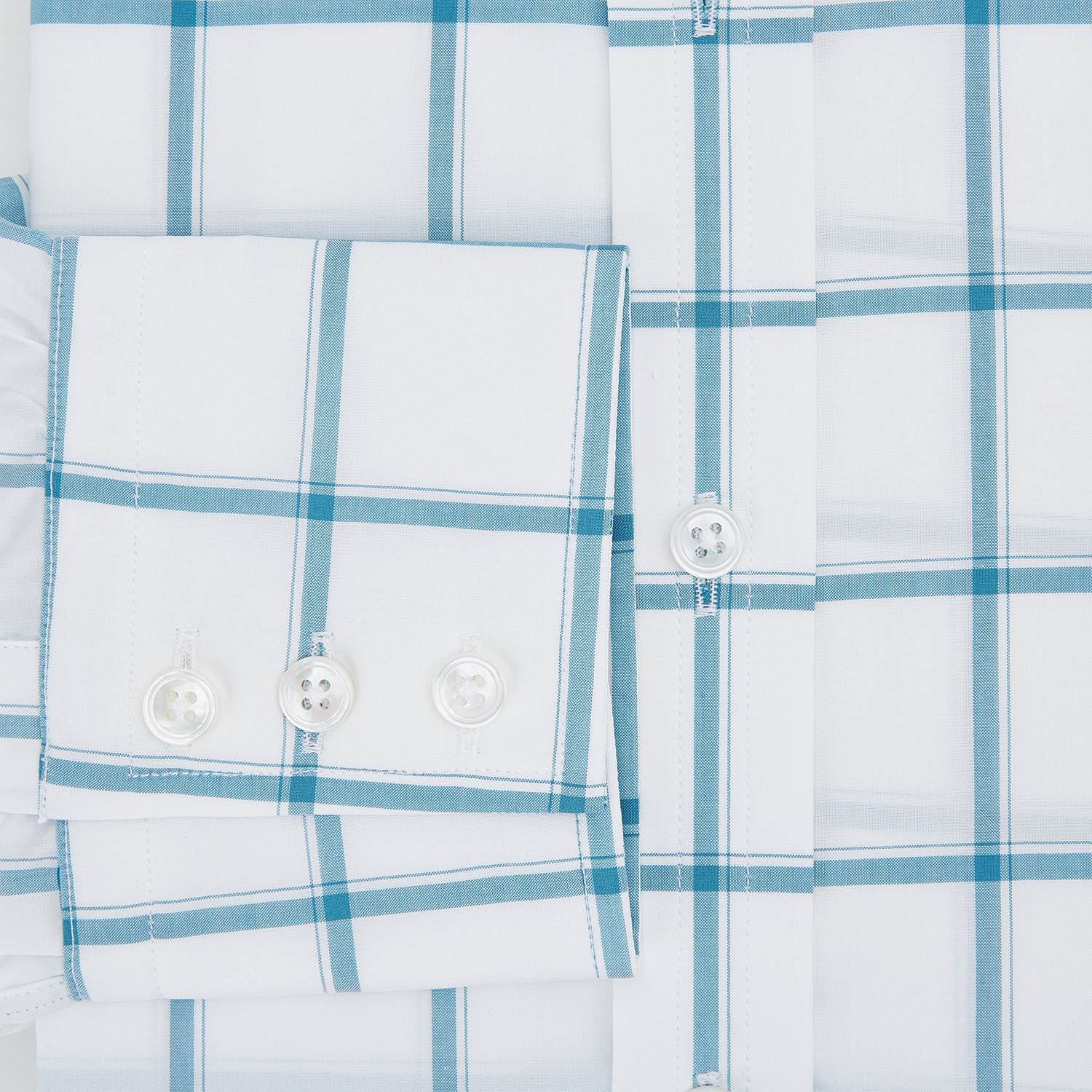 View 4 of product The Turnbull & Asser Turquoise Grid Check Mayfair Shirt is crafted from Italian cotton with a white base and turquoise grid pattern, featuring long sleeves, a pointed collar, and buttoned cuffs.