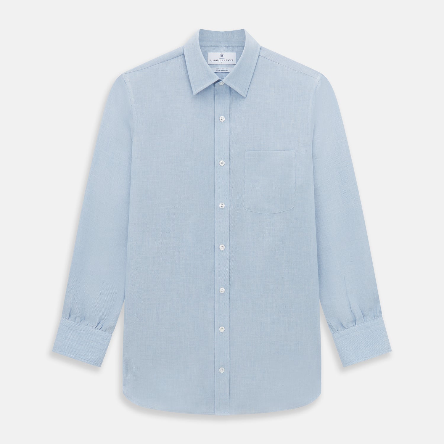 View 1 of product The Turnbull & Asser Pale Blue Cotton Cashmere Derby Collar Richmond Shirt features a soft cotton-cashmere blend, derby collar, white buttons, left chest pocket, and buttoned cuffs, shown laid flat on a white background.