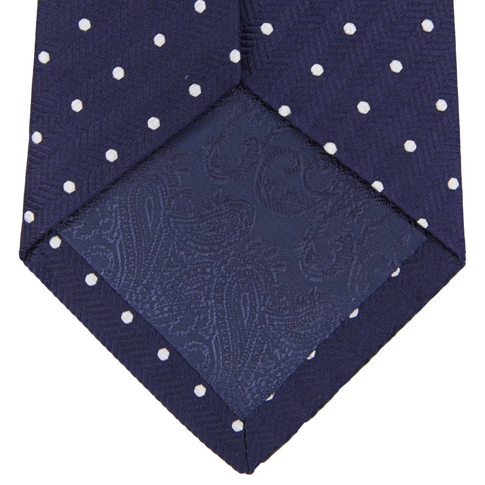 View 4 of product The Turnbull & Asser Herringbone Silk Spot Tie features a navy blue design with evenly spaced white polka dots—an essential accessory for refined, sophisticated looks.