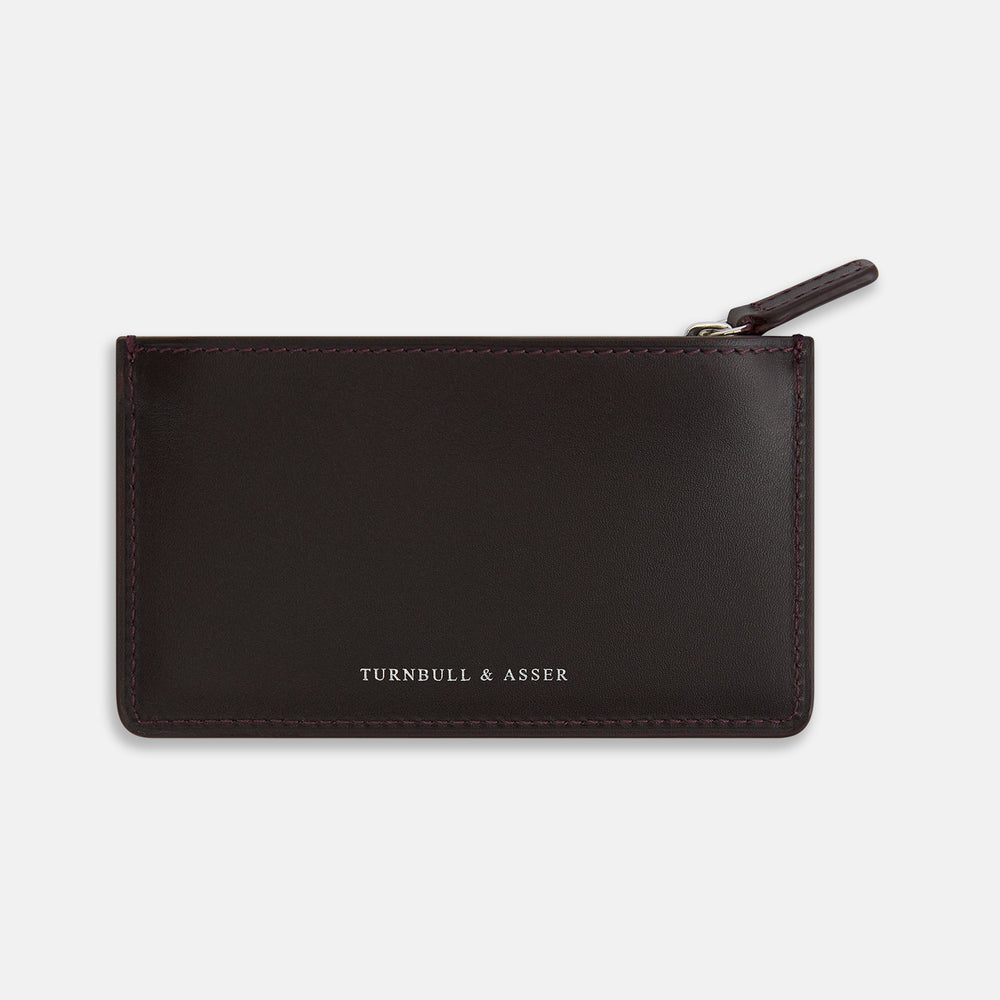 A Burgundy Leather Zip Wallet by Turnbull & Asser, featuring the brand's white logo near the bottom center, displayed on a plain white background.