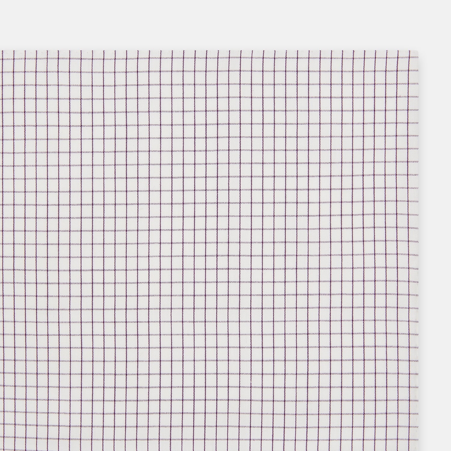 View 2 of product The Turnbull & Asser Hand Rolled Purple Graph Check Handkerchief features a white cloth with evenly spaced thin purple lines forming small squares, neatly laid flat against a white background.