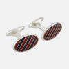 View 1 of product The Burgundy and Navy Striped Oval Enamel Cufflinks by Turnbull & Asser feature a silver oval design with bold stripes, adding a touch of masculine elegance to any ensemble.